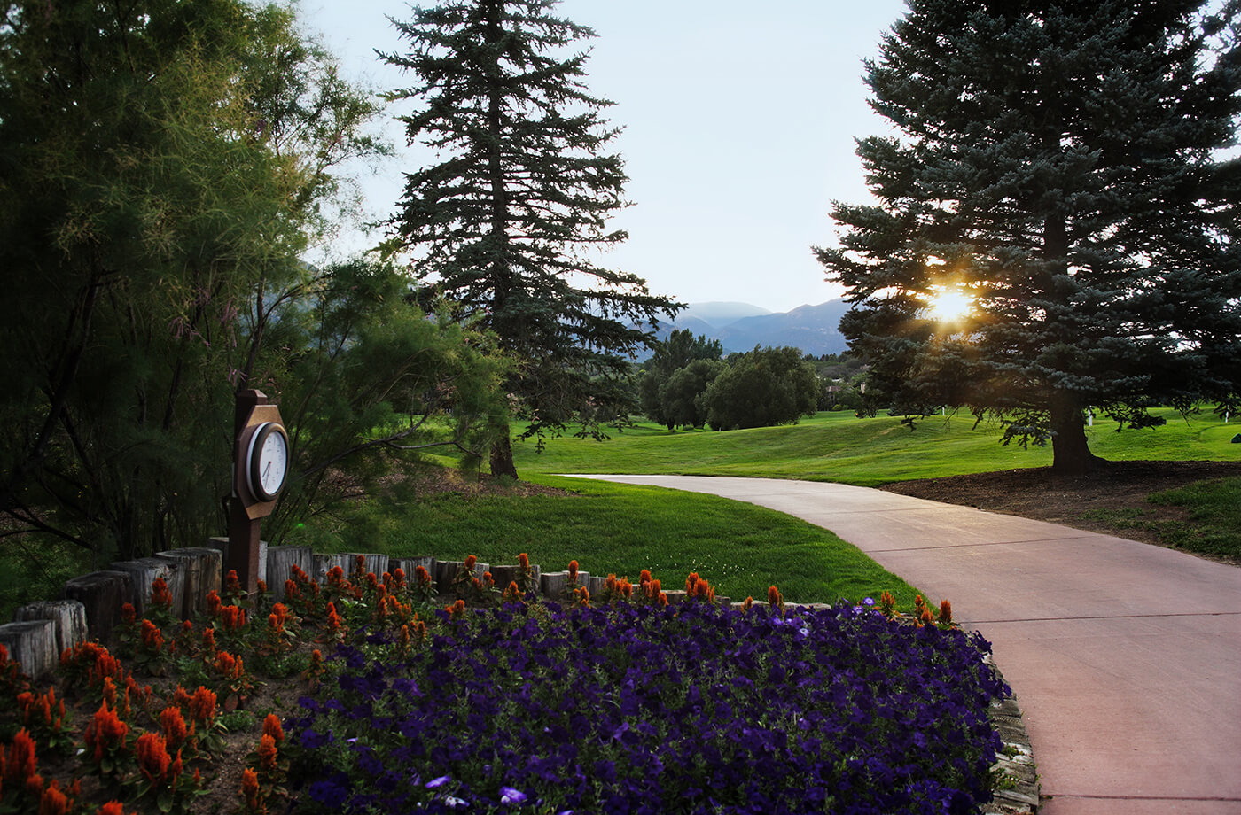 golf course walkway with flowers and clock